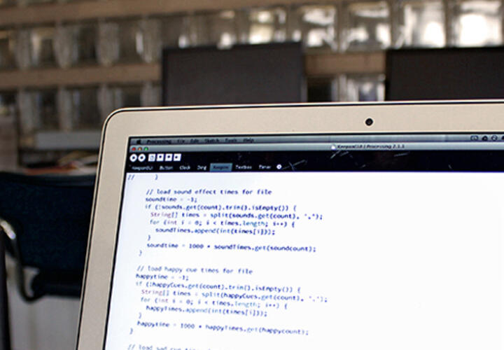 a laptop screen displaying lines of code